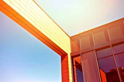 Business architecture. Picture of business office building with blue summer sky and sunlight.