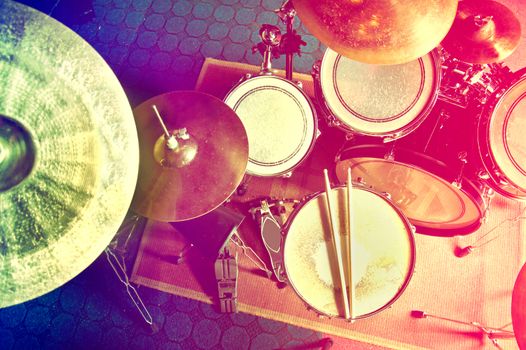 Drums conceptual image. Picture of drums and drumsticks lying on snare drum. Retro vintage instagram picture.