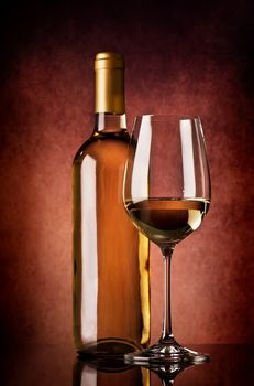 Semi-dry white wine on a brown background