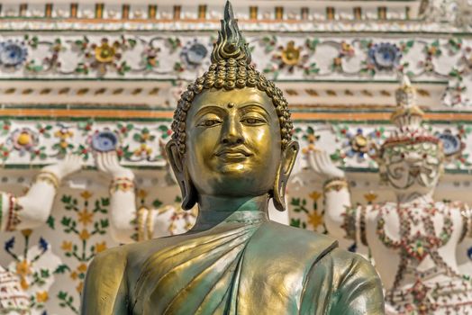 Close up of statue of lord Buddha made of bronze at Wat Arun - Temple of dawn in Bangkok, Thailand