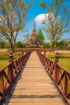 Bridge across a lake leading to Wat Sa Si temple in Sukhothai Historic Park in Thailand