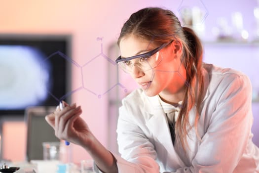 Life science researcher working in laboratory. Portrait of a confident female health care professional in his working environment reviewing structural chemical formula written on a glass board.