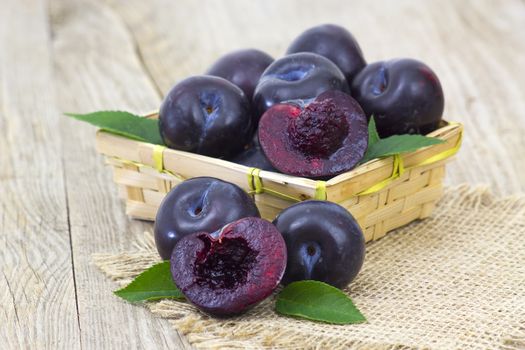 fresh fruits in a basket on wooden background