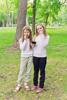 Photo of cute two eating blond girls