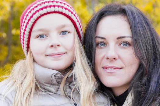 Portrait of happy mother and daughter in autumn