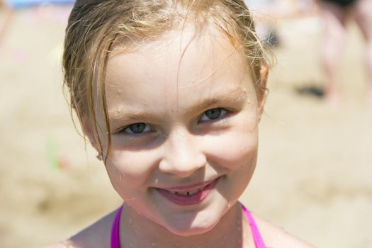 Cute girl with blond long hair and blue eyes