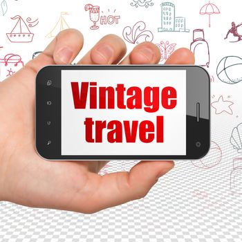 Tourism concept: Hand Holding Smartphone with  red text Vintage Travel on display,  Hand Drawn Vacation Icons background