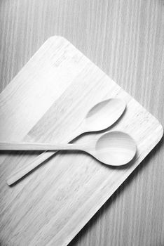 wood spoon with cutting board on table background  black and white color tone style
