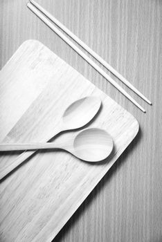 wood spoon with cutting board on table background black and white color tone style