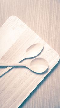 wood spoon with cutting board on table background vintage style