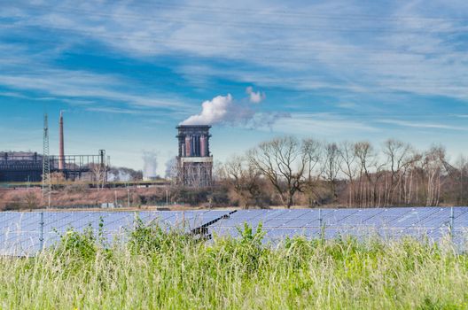 Old power plant on a greenfield site against a blue sky. Previously a large solar plant.