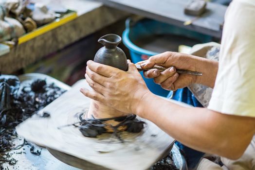 Hands working on pottery wheel of thailand