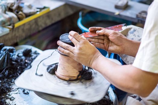 Hands working on pottery wheel of thailand