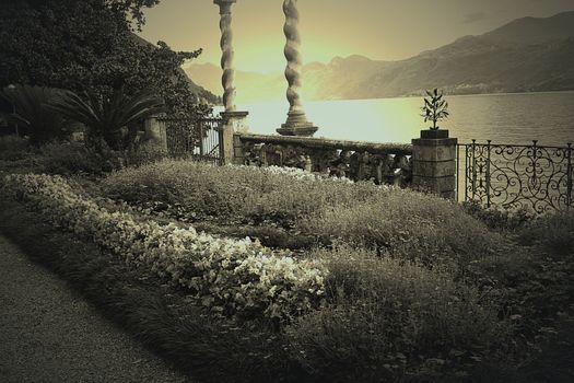 Photo in sepia of a terrace with flowers in Varenna, on Lake Como, Italy