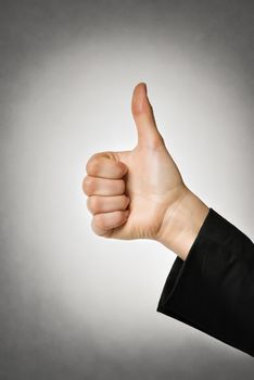 Image of a right hand with thumb up of a businesswoman