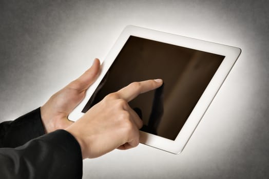Closeup business woman points to a tablet computer with free space