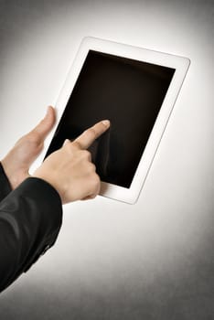 Closeup business woman points to a tablet computer with free space