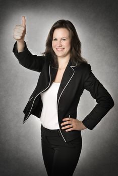 Business woman woman standing in office and holding her thumb up