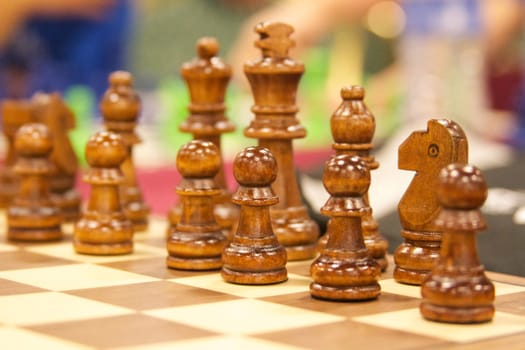 a wooden chess set stands ready for battle