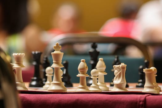 a chess board stands ready for the start of a tournament