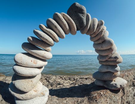 White pebbles laid out in the form of a arc on the coast