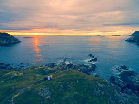 Scenic view of midnight sun on rocky coast of Vesteralen inslands in Norway