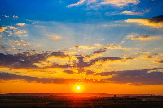 Orange and blue colorful dramatic sunset with clouds