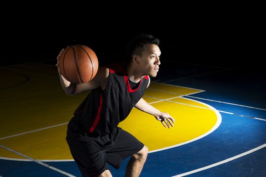 Asian young basketball player on basketball court