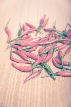 red chili peppers on wood table background vintage style