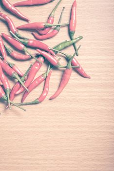 red chili peppers on wood table background vintage style