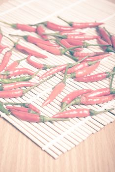 red chili peppers on wood table background vintage style
