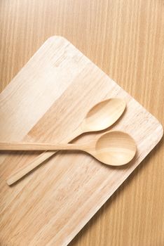wood spoon with cutting board on table background