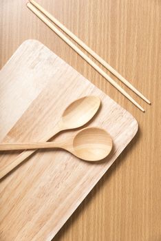 wood spoon with cutting board on table background