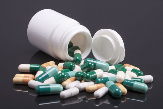  Group of two-piece medical capsule with box  isolated on black  background