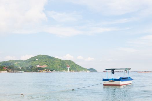 Small boat at sea. The ship tied up at the beach.