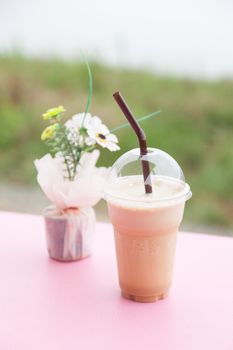 Coffee in plastic cup. Iced coffee in a plastic cup is placed on the table.