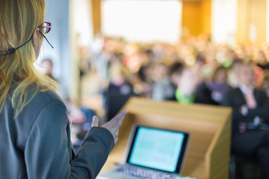 Female speaker at Business Conference and Presentation. Audience at the conference hall. Business and Entrepreneurship. Business woman.