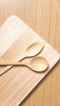 wood spoon with cutting board on table background