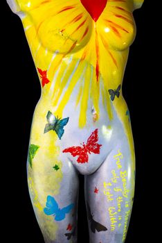 front of an multi colored artistic painted female mannequin torso with clipping path