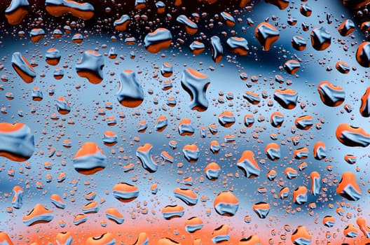 Black blue orange background with water drops pattern.