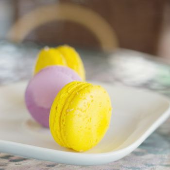 Macaroon dessert yelow served on a table