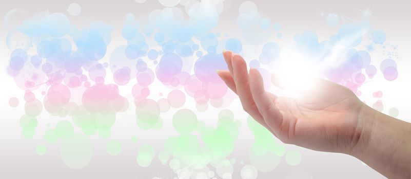 Healing Hand on a sparkling pastel coloured background