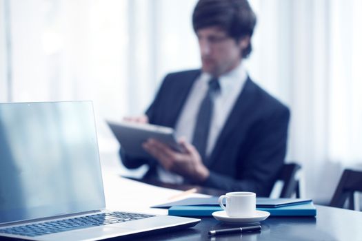 businessman with tablet at work meeting