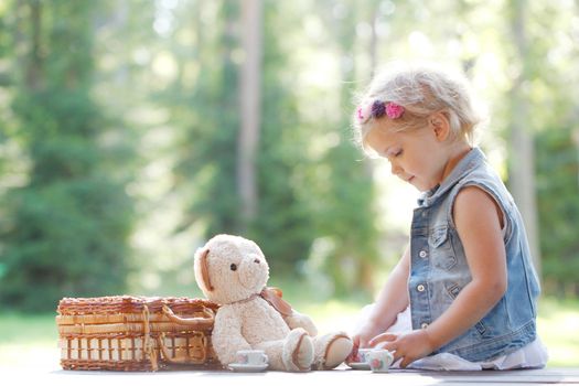 portrait of young girl playing with teddybear
