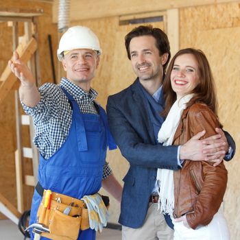 foreman shows new house to a young couple