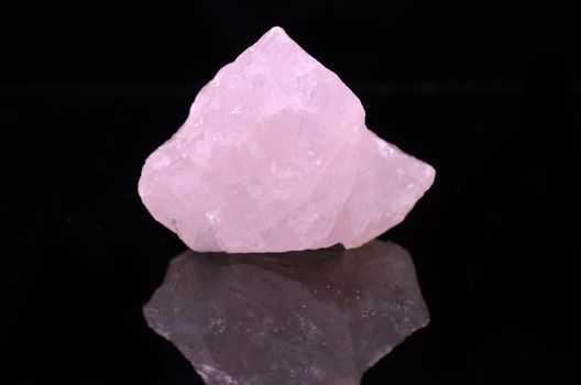 Sample of a beautiful Rose Quartz nature specimen isolated on black background