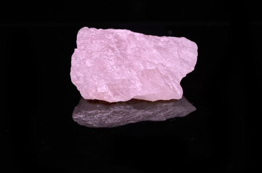 Sample of a beautiful Rose Quartz nature specimen isolated on black background