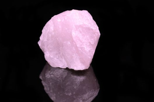 Sample of a beautiful Rose Quartz nature specimen isolated on black background