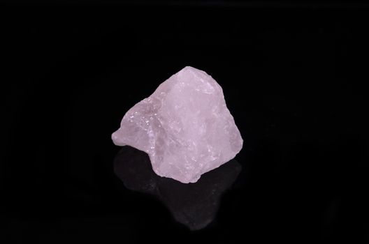 Sample of a beautiful Rose Quartz nature specimen isolated on black background