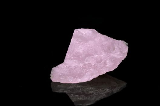 Sample of a beautiful Rose Quartz nature specimen isolated on black background